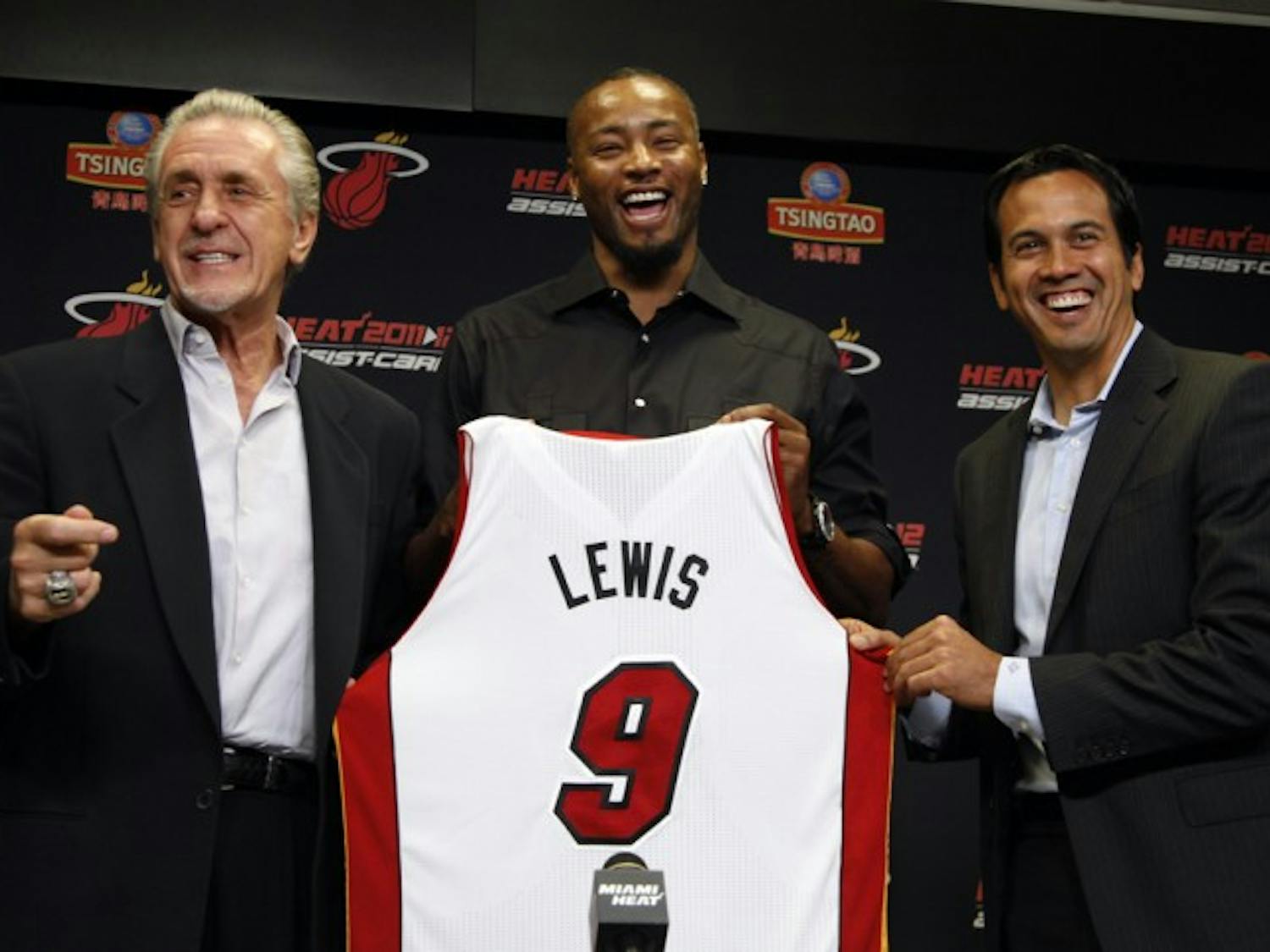 Miami Heat president Pat Riley, left, forward Rashard Lewis, center, and head coach Erik Spoelstra, right, hold up Lewis' jersey after he signed an NBA basketball contract with the Heat, Wednesday, July 11, 2012, in Miami. (AP Photo/Lynne Sladky)