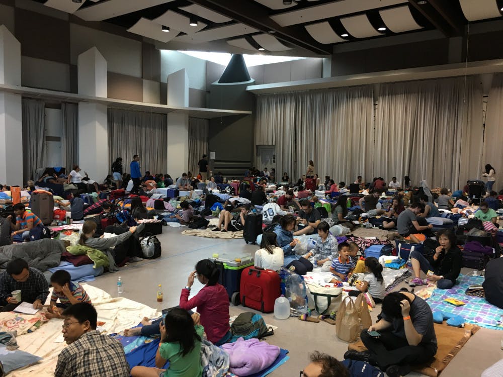 About 200 UF students, faculty, staff and families sit inside the Steinbrenner Band Hall, a designated hurricane shelter that hit maximum capacity.