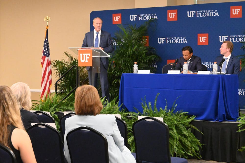 UF presidential finalist Stuart Bell speaks with Rahul Patel and Matthew Bravo at a forum at Emerson Hall, Wednesday, June 3, 2026 in Gainesville, Fla.