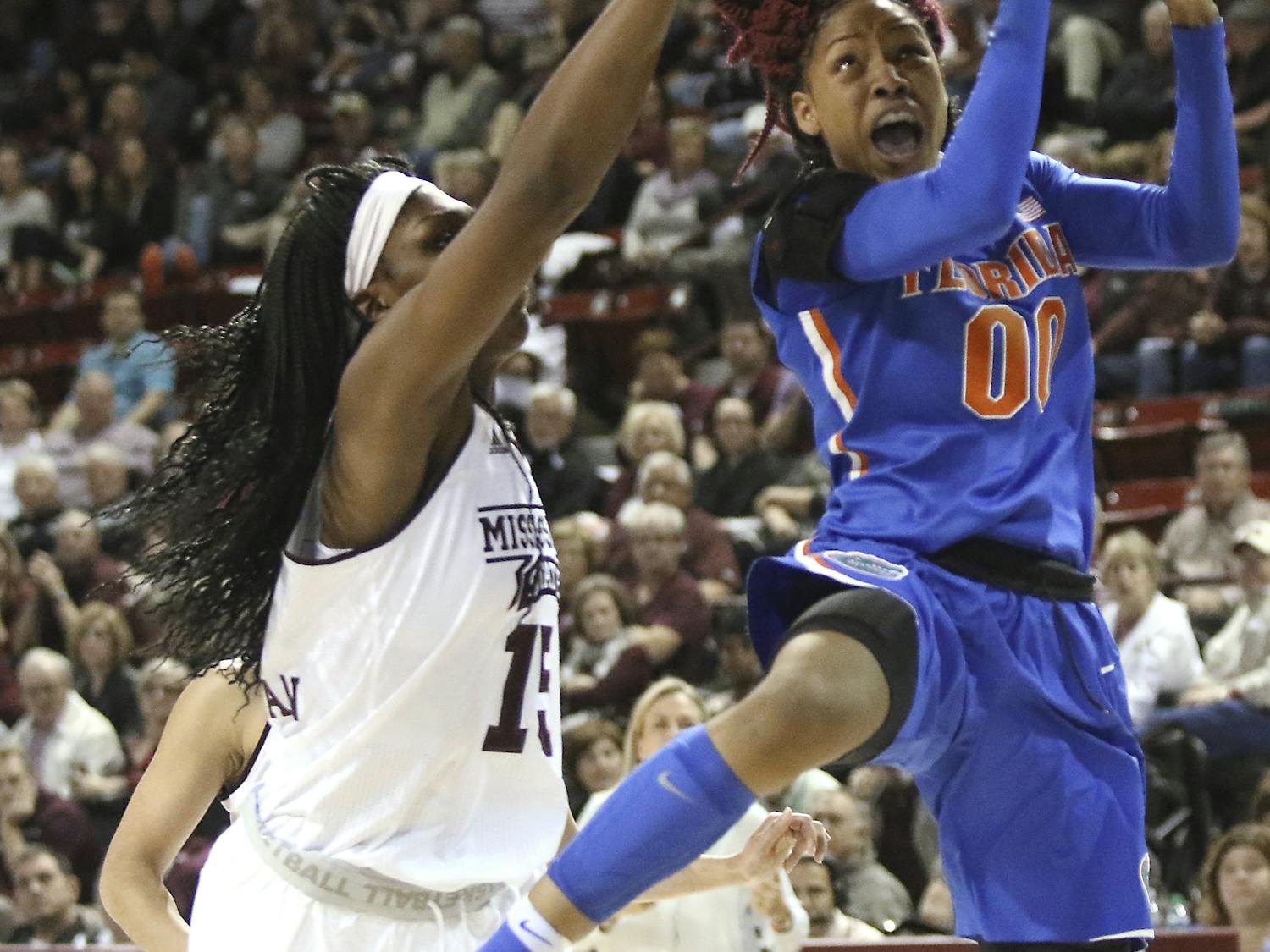 Florida guard Delicia Washington (0) drives to the basket around Mississippi State center Teaira McCowan (15) during the second half of an NCAA college basketball game in Starkville, Miss., Thursday, Jan. 12, 2017. (AP Photo/Jim Lytle)