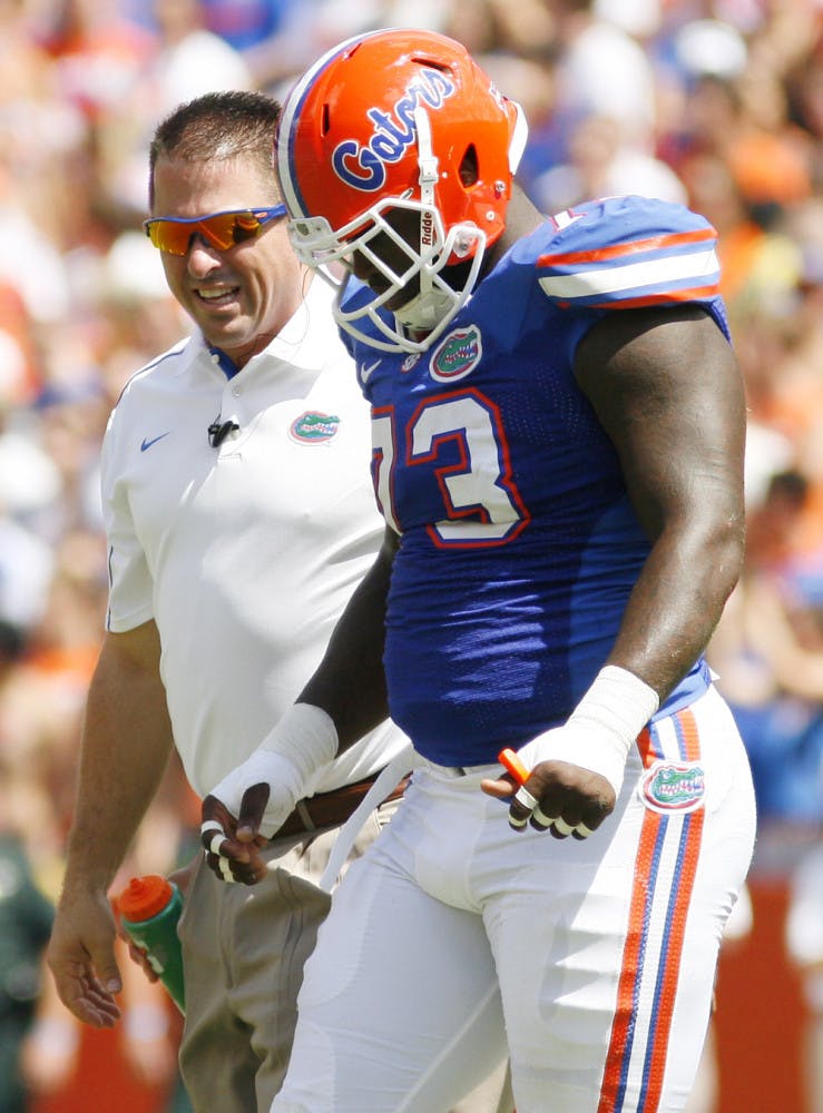 Junior defensive lineman Sharrif Floyd limps off the field during a game against Kentucky at Ben Hill Griffin Stadium on Saturday. Floyd was one of several Florida players who suffered injuries during the conference game.