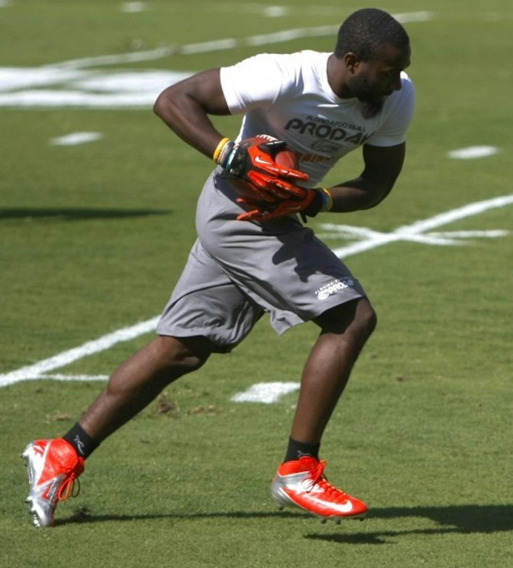 <p>Former Florida running back Chris Rainey hauls in a catch during the Gators’ pro day on March 13. Rainey is projected as high as a third- or fourth-round pick in Thursday’s draft.</p>