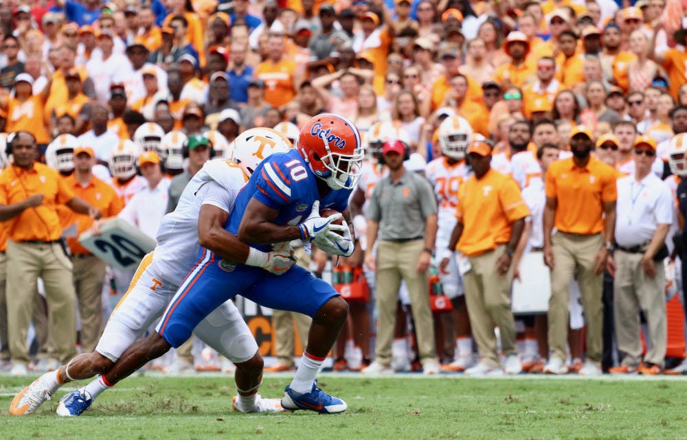 <p>UF receiver Josh Hammond gets tackled while holding the ball during Florida's 26-20 win against Tennessee on Sep. 16, 2017, at Ben Hill Griffin Stadium.</p>