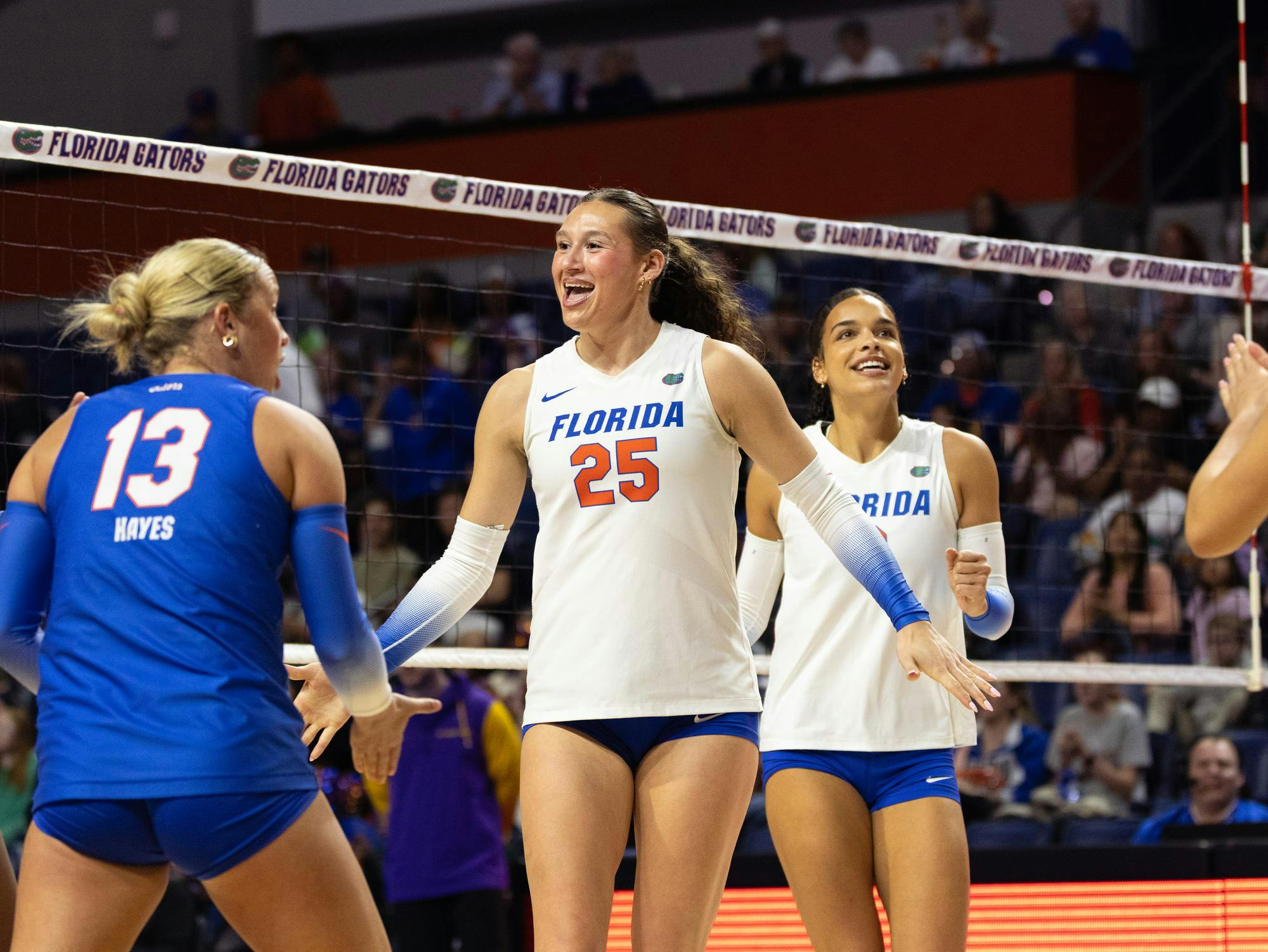 Florida middle blocker Alec Rothe (25) and opposite hitter Logan King (8) celebrate with team during an NCAA volleyball game against LSU, Friday, Oct. 23, in Gainesville, Fla.