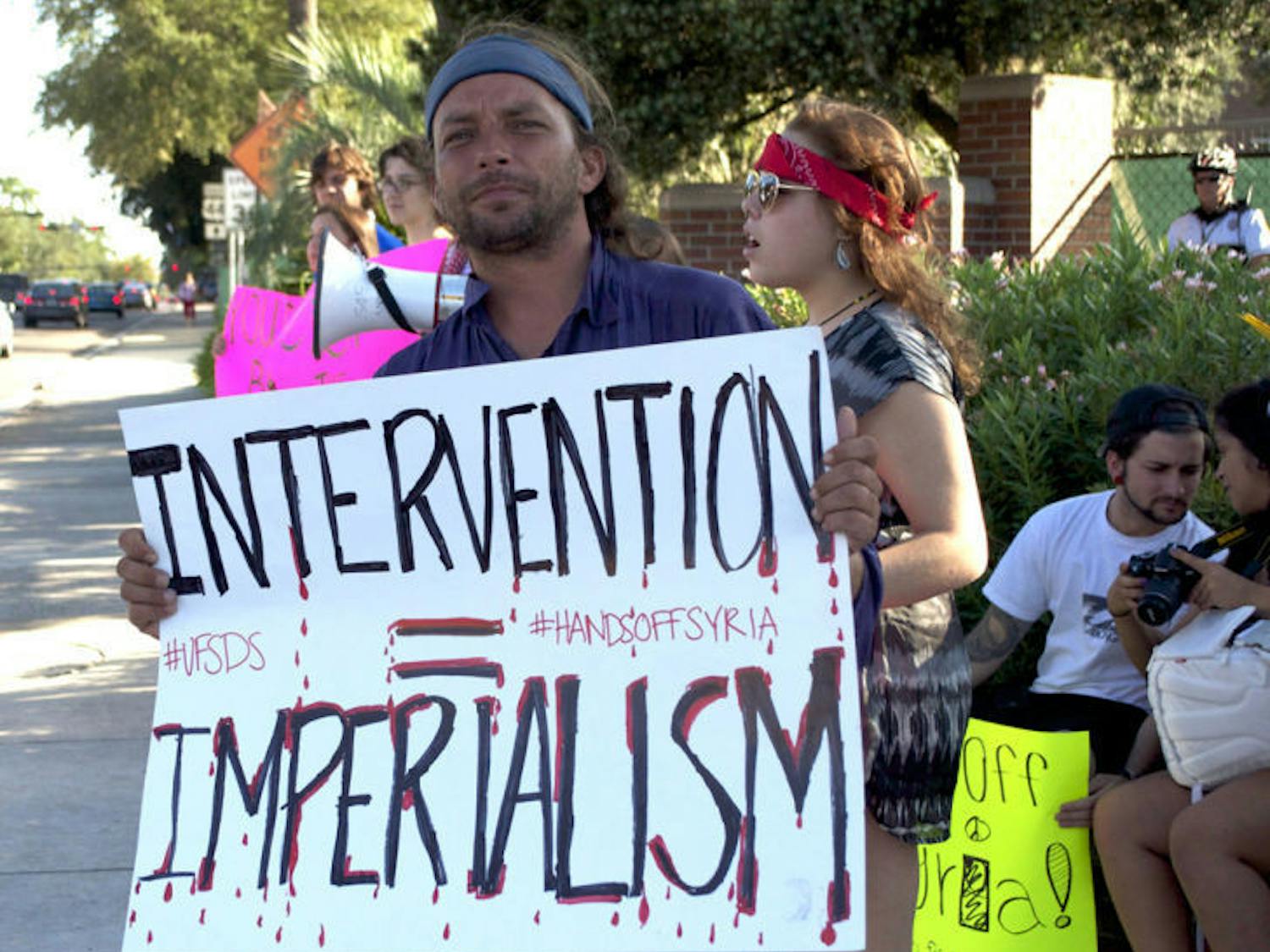 UF Students for a Democratic Society protest the United States’ intervention in Syria. Obama addressed the nation Tuesday night and called for diplomacy but left options open for military action.