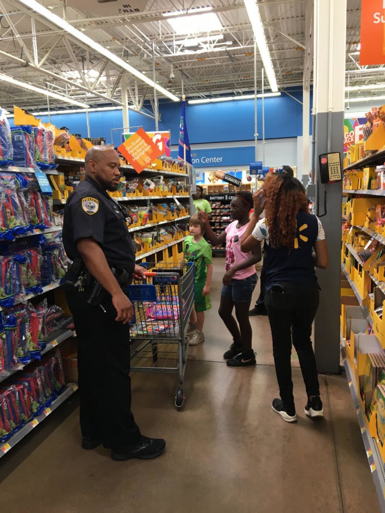 School resource officer pictured with Logan Robbins (green shirt) and Nyla Francois, 10, (pink shirt) and a Walmart employee.
&nbsp;