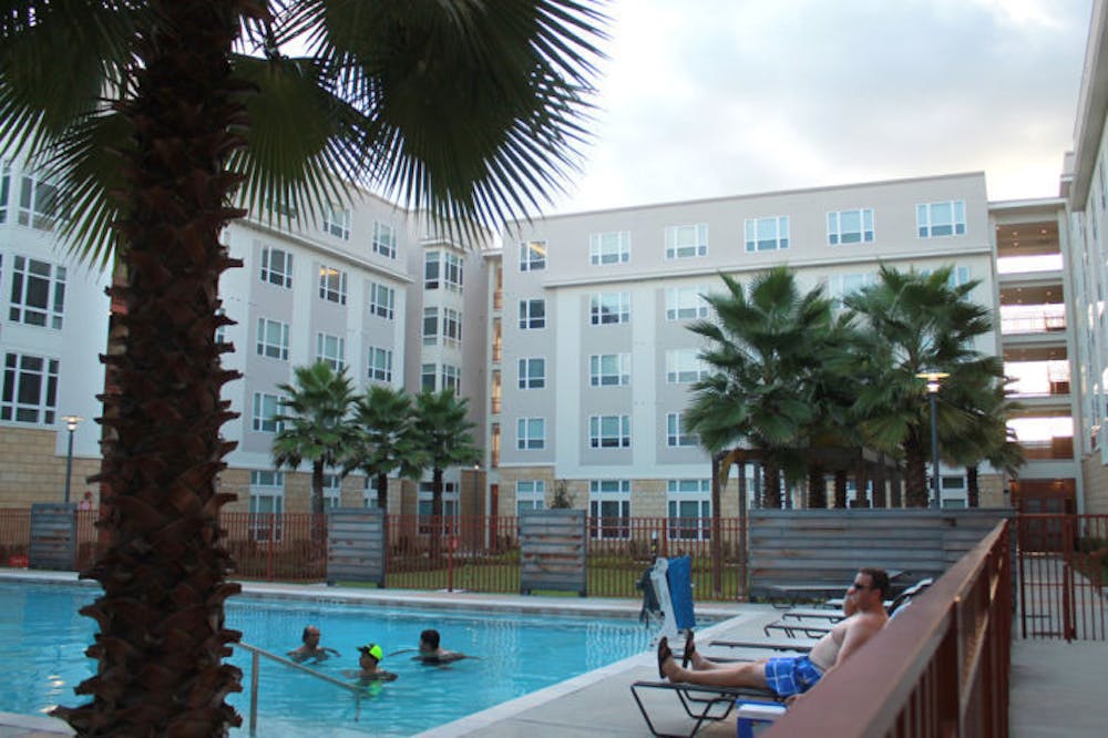 <p>Residents relax in the courtyard of The Continuum apartment complex Monday. A UF graduate and local attorney recently filed a complaint citing inconsistent leasing policies.</p>