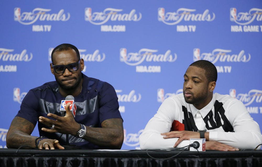 LeBron James, left, and Dwyane Wade speak to the media after the Miami Heat’s 104-87 loss to the San Antonio Spurs in Game 5 of the NBA finals on Sunday night.