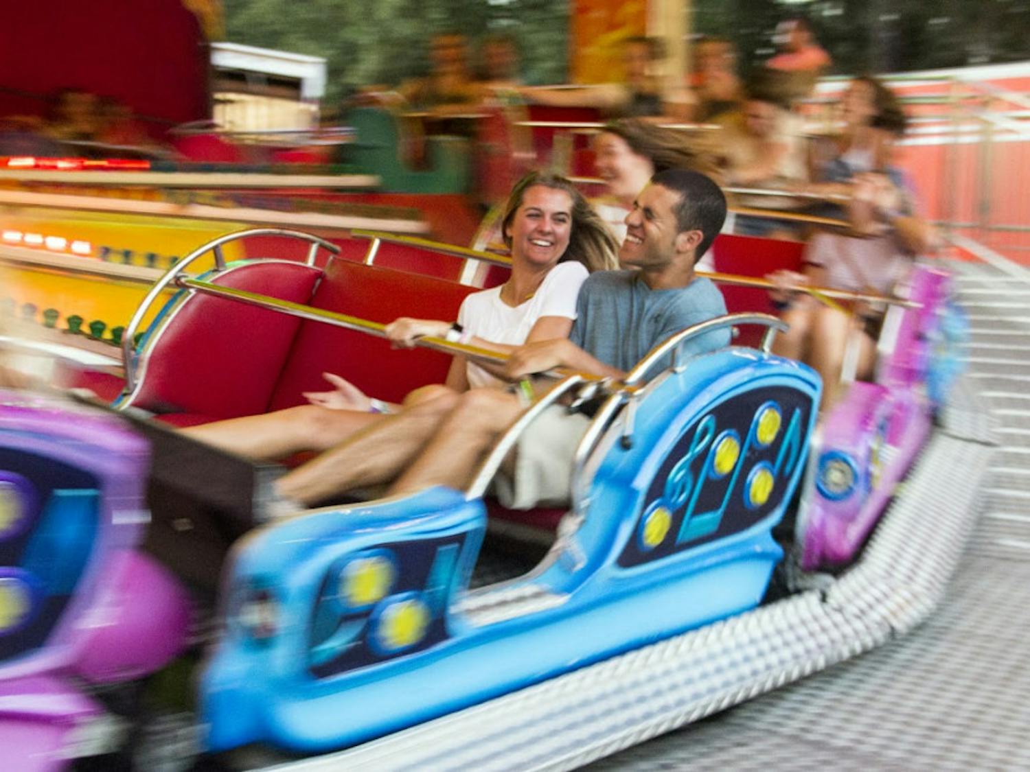 Emma Hennessey, a 19-year-old UF business sophomore, rides the “Rock and Roll” with 19-year-old Demarco Reaves Saturday evening at the Alachua County Fair. Reaves was happy to experience a local event because he was visiting Hennessey from North Carolina. Look at the gallery here.