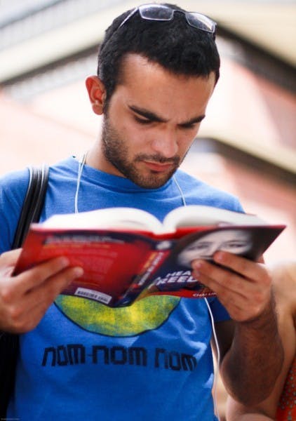 Chinese major senior Andrew Salcedo flips through the memoir of Chai Ling, the founder of All Girls Allowed on Turlington Plaza Friday.
&nbsp;