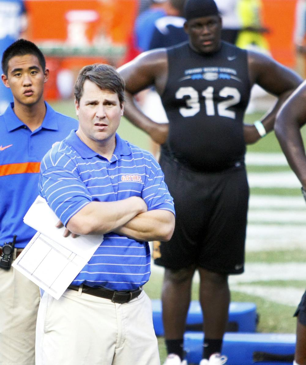 <p>Florida coach Will Muschamp looks on at the 2012 Friday Night Light football camp July 27. More than 200 high school athletes attended to participate in drills.</p>