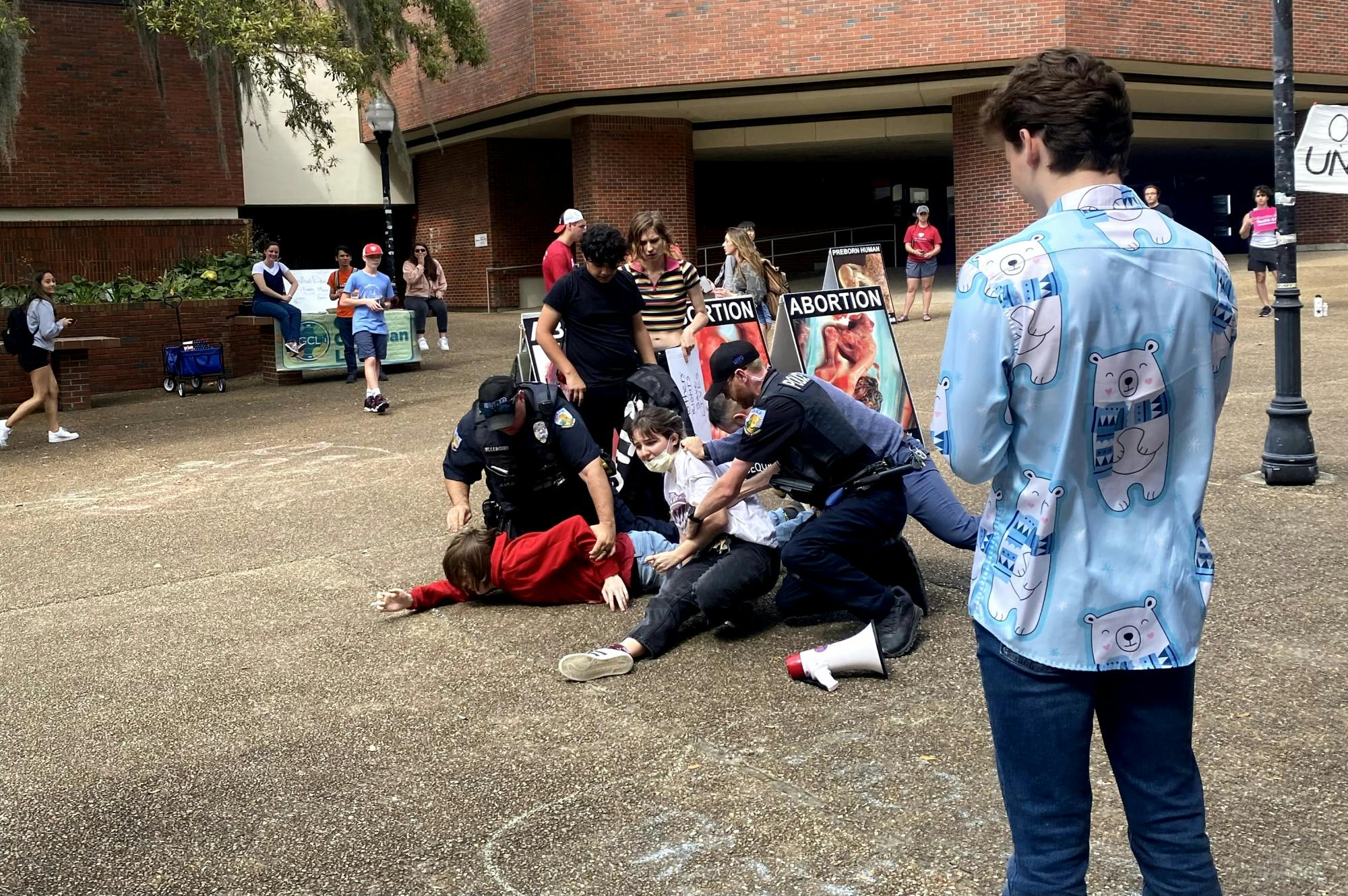 Two UF students are arrested by University Police Department officers in Turlington Plaza Friday, March 10, 2023.