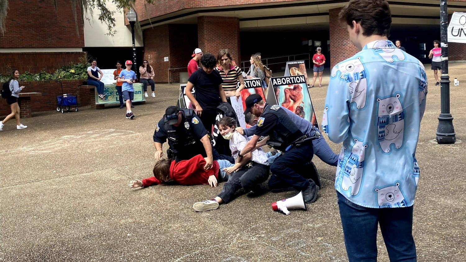 Two UF students are arrested by University Police Department officers in Turlington Plaza Friday, March 10, 2023.