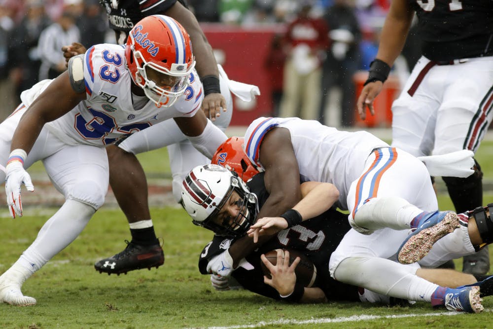 <p><span>South Carolina's Ryan Hilinski, bottom, gets sacked by Florida's Zachary Carter, right, in the first half of an NCAA college football game Saturday, Oct. 19, 2019, in Columbia, SC. Florida defeated South Carolina 38-27.</span></p>