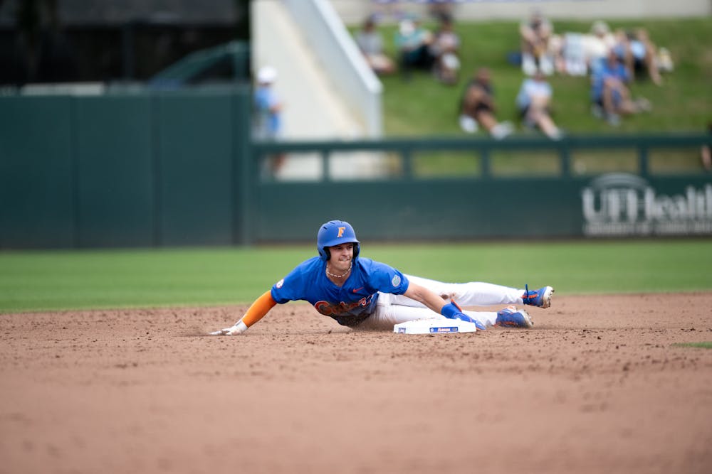 Florida Gators outfielder/infielder Ashton Wilson (30) dives past second base while stealing in a baseball game against the Air Force Academy in Gainesville, Fla., on Friday, Feb. 15, 2025.