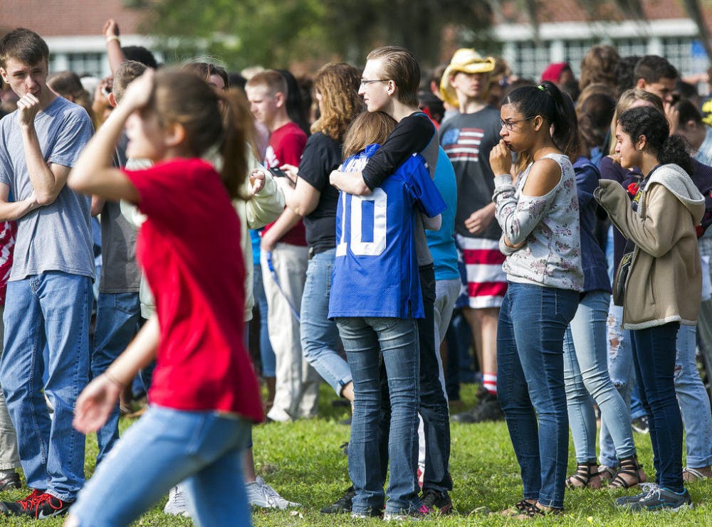Forest High School students console one another after a school shooting at Forest High School Friday, April 20, 2018 in Ocala, Fla. One student shot another in the ankle at the high school and a suspect is in custody, authorities said Friday. The injured student was taken to a local hospital for treatment.&nbsp;