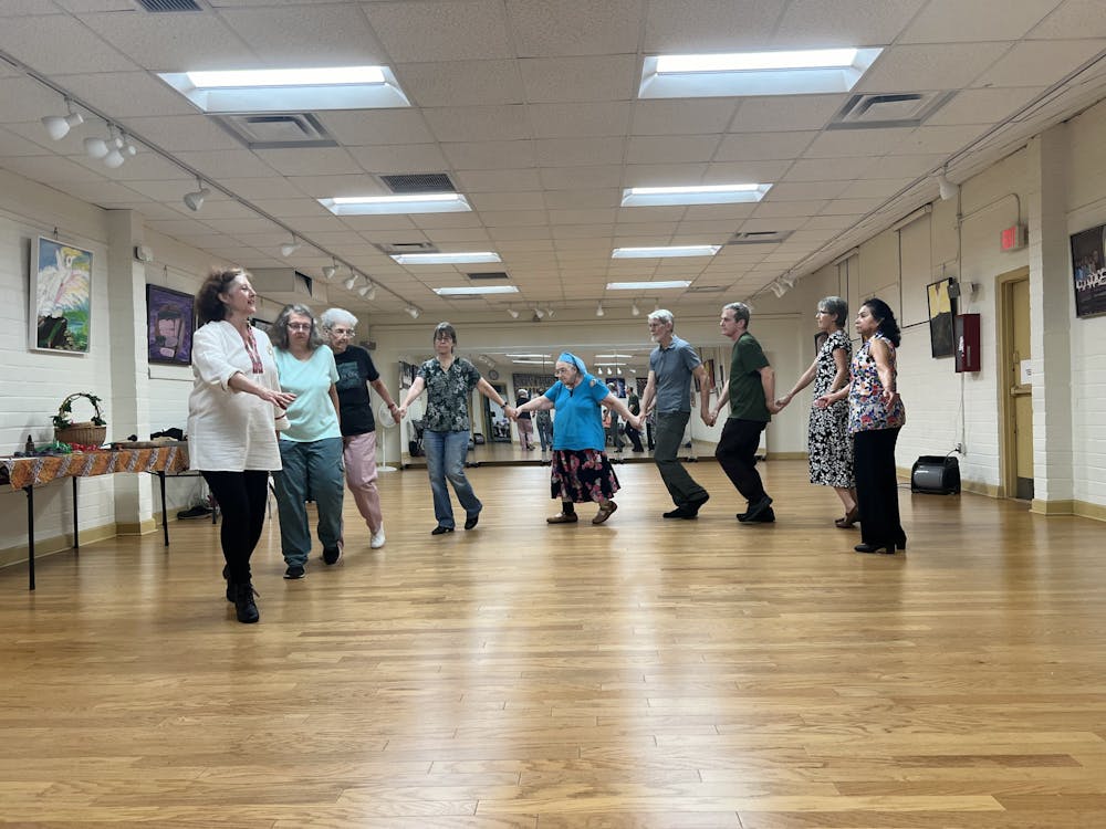 People participate in an international folk dance class on Wednesday, July 31, 2024.