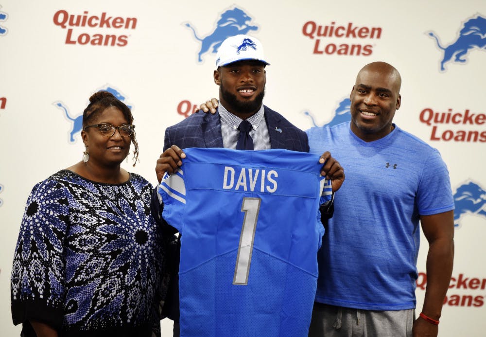 <p>Former UF linebacker Jarrad Davis poses with his parents, Amy and John Davis, at a Detroit Lions press conference on April 28, 2017, in Allen Park, Michigan. Davis was selected 21st overall by the Lions in the 2017 NFL Draft.</p>
