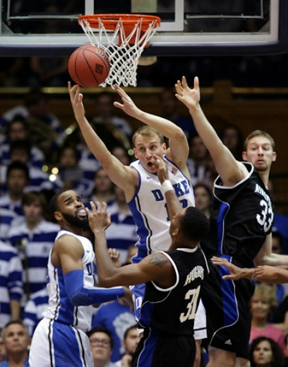 <p>Former Duke forward Alex Murphy (middle) pulls down a rebound during a game this season against UNC Asheville. Murphy will transfer from Duke to Florida.</p>