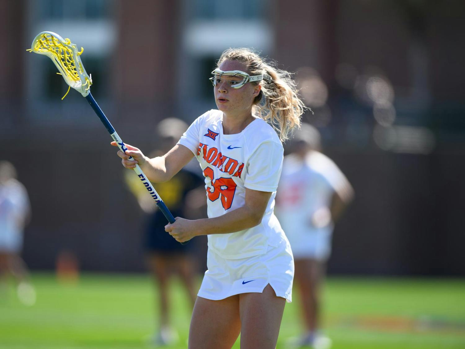 Florida attacker Ava Kristynik (39) passes during the first half of an NCAA lacrosse match against Michigan, Friday, Feb. 13, 2026, in Gainesville, Fla.
