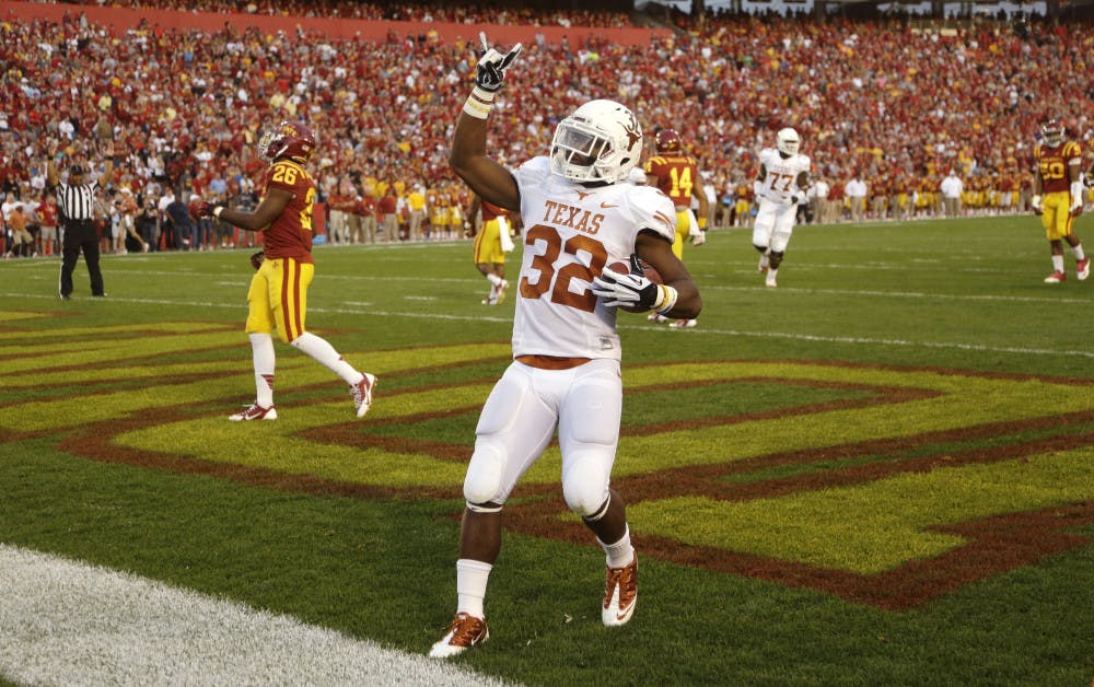 <p>Texas running back Johnathan Gray celebrates after scoring on a 45-yard touchdown run in the first half of his team's 31-30 win against Iowa State on Oct. 3, 2013 in Ames, Iowa.</p>