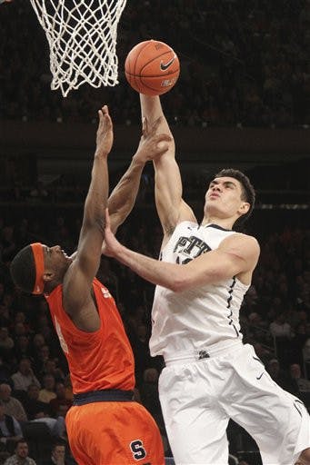 Pittsburgh's Steven Adams (13) goes up past Syracuse's C.J. Fair during the first half of an NCAA college basketball game at the Big East Conference tournament, Thursday, March 14, 2013 in New York. (AP Photo/Mary Altaffer)