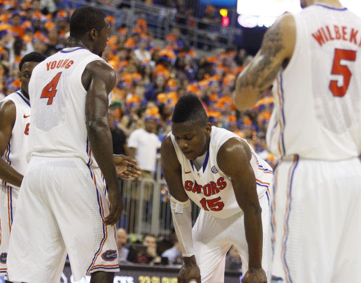 Junior forward Will Yeguete (15) rests with his hands on his knees during Florida’s 75-36 win against South Carolina on Jan. 30 in the O’Connell Center.
