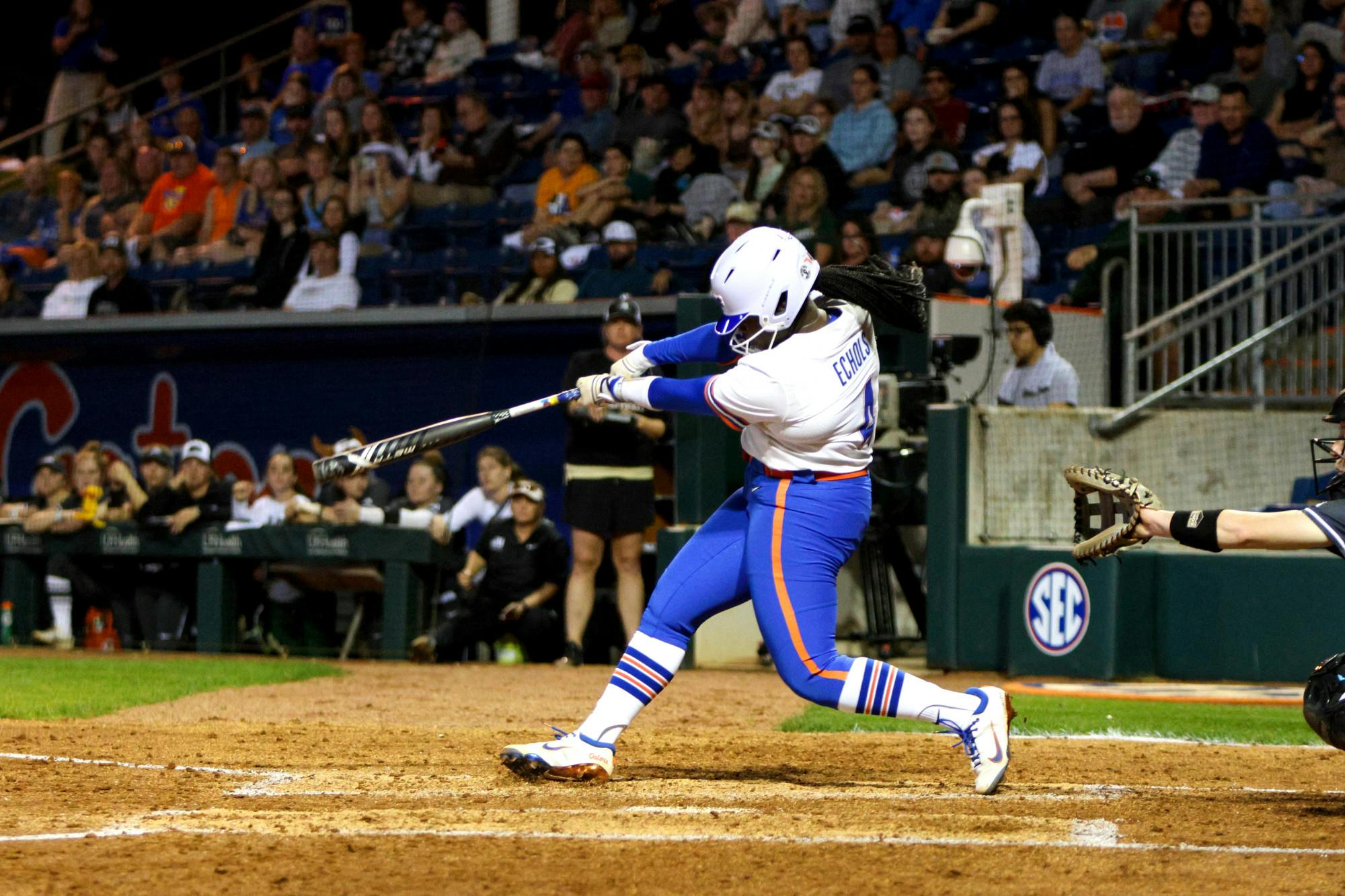 Gators softball player Charla Echols hits a three-run home run against the Jacksonville Dolphins in an 11-0 victory Wednesday, Feb. 15, 2023. 