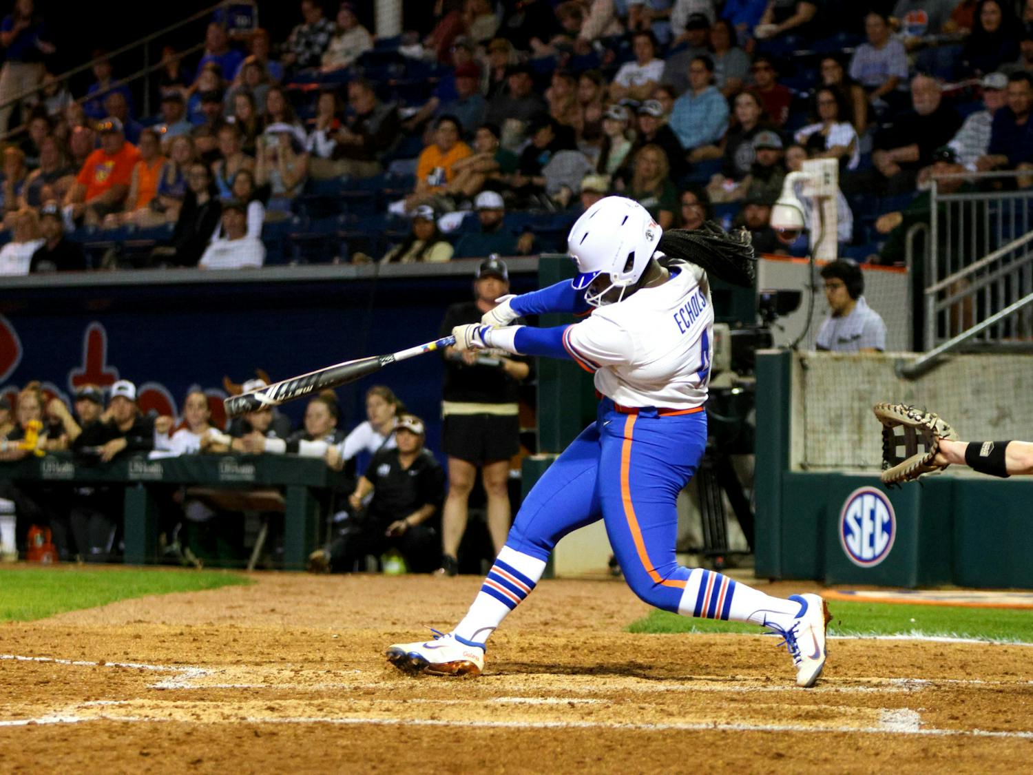 Gators softball player Charla Echols hits a three-run home run against the Jacksonville Dolphins in an 11-0 victory Wednesday, Feb. 15, 2023. 