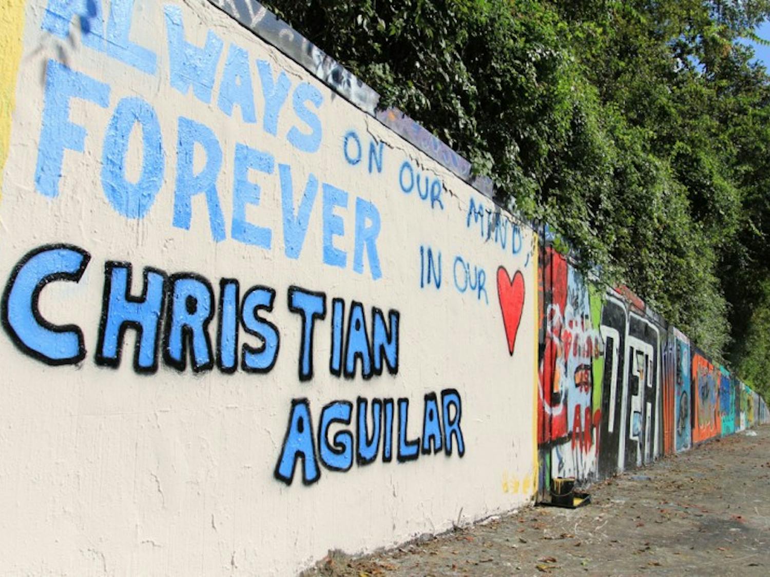 Supporters of the Aguilar family painted a memorial to Christian Aguilar on the 34th Street Wall on Saturday afternoon.