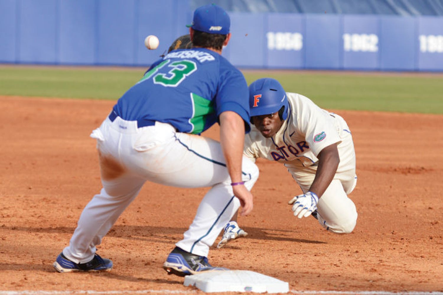 Josh Tobias dives back to first base to avoid being picked off during Florida’s 8-3 loss against Florida Gulf Coast on Feb. 23, 2013. Tobias suffered a broken toe last year but is healthy to start the 2014 season.