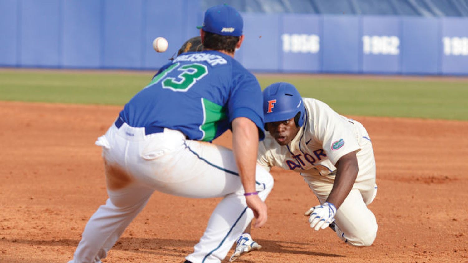 Josh Tobias dives back to first base to avoid being picked off during Florida’s 8-3 loss against Florida Gulf Coast on Feb. 23, 2013. Tobias suffered a broken toe last year but is healthy to start the 2014 season.