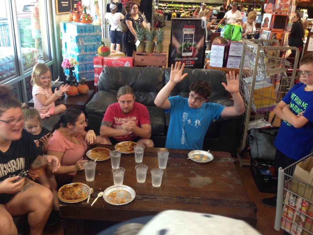 <p dir="ltr"><span>Steven Edvalson raises his hands in victory after finishing his pumpkin pie on Sunday at Lucky’s Market. Edvalson ate his pie in fewer than seven minutes during a pie-eating contest at the grocery store.</span></p>