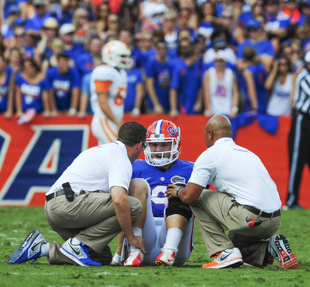 Quarterback Jeff Driskel is attended to by trainers during Florida's 31-17 win against Tennessee on Saturday in Ben Hill Griffin Stadium. Driskel will miss the remainder of the season with a fractured right fibula.