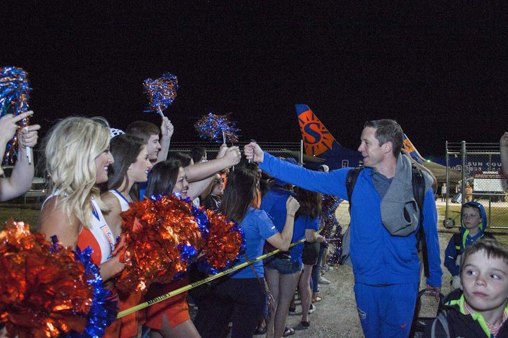 <p>UF head coach Mike White greets fans at the Gainesville Regional Airport on Sunday.&nbsp;</p>