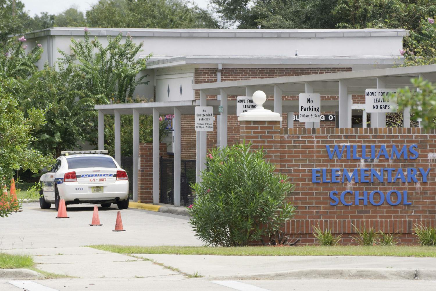 An Alachua County Sheriff's Office police car is stationed outside Joseph Williams Elementary School Aug. 28, 2015.