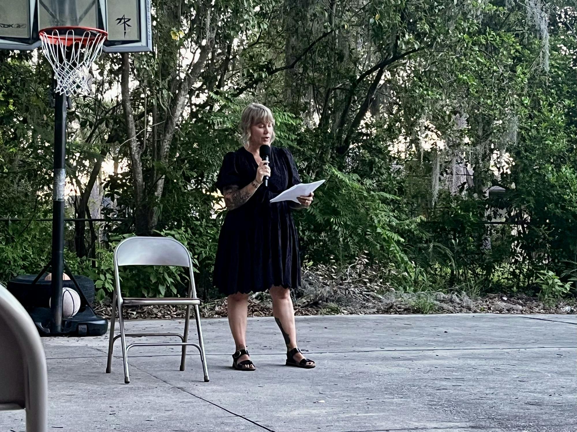Emily Westerholm, the founder and executive director of Released Reentry, recites a poem at an Open Mic Poetry Nights event at Released Reentry in Gainesville, Fla., on June 10, 2026. 