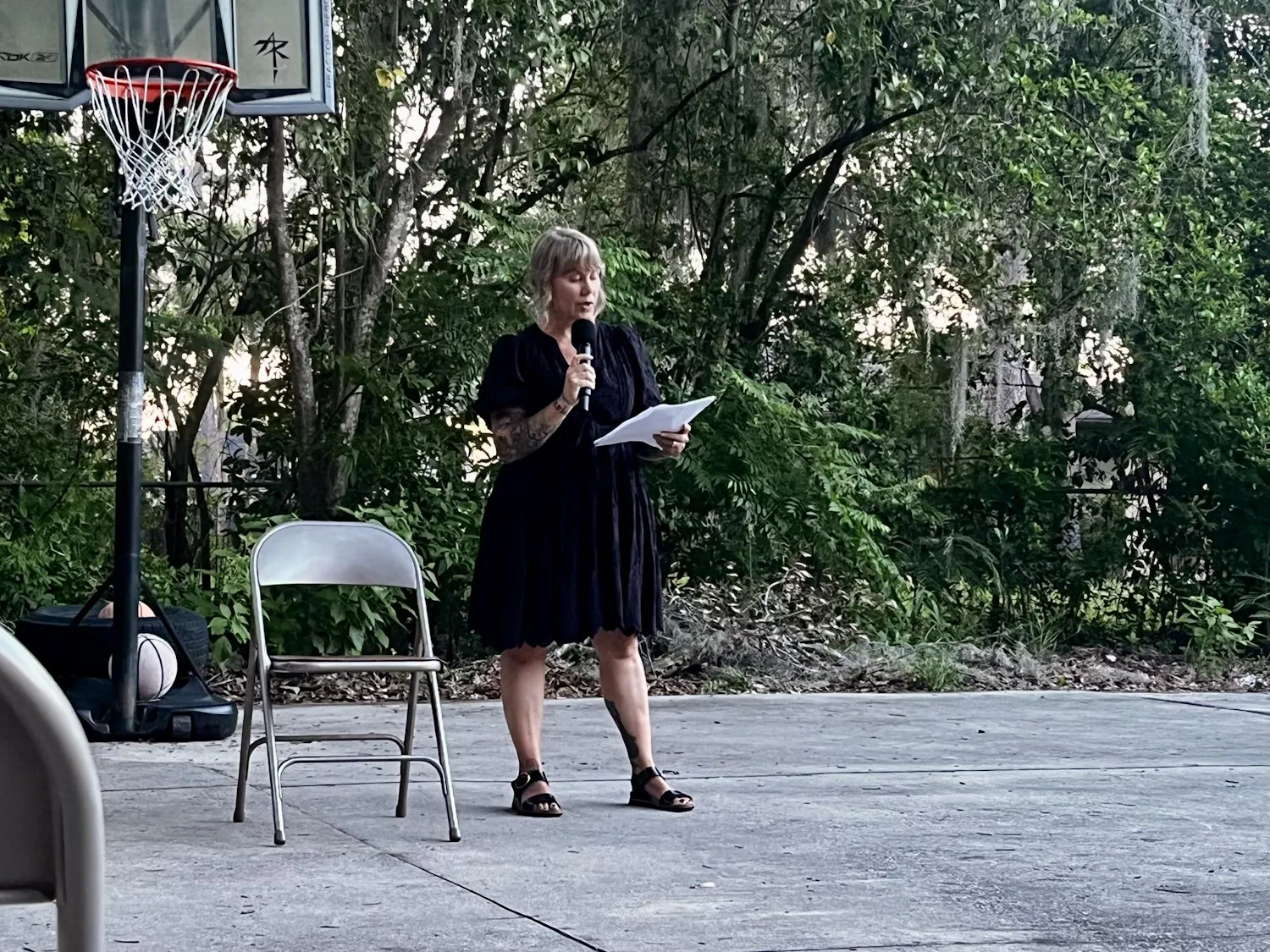 Emily Westerholm, the founder and executive director of Released Reentry, recites a poem at an Open Mic Poetry Nights event at Released Reentry in Gainesville, Fla., on June 10, 2026.