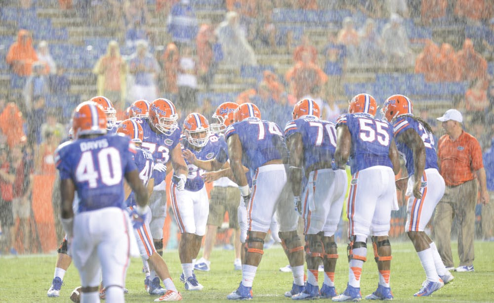 Florida huddles on the field prior to kickoff in its season opener against Idaho on Saturday at Ben Hill Griffin Stadium. The game, which was initially delayed two hours and 48 minutes due to lightning, was suspended after field conditions were deemed unsafe to play. Details regarding rescheduling have yet to be finalized.