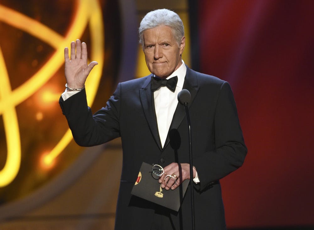 This May 5, 2019, file photo shows Alex Trebek gestures while presenting an award at the 46th annual Daytime Emmy Awards in Pasadena, Calif. Jeopardy!” host Alex Trebek died Sunday, Nov. 8, 2020, after battling pancreatic cancer for nearly two years. Trebek died at home with family and friends surrounding him, “Jeopardy!” studio Sony said in a statement. Trebek presided over the beloved quiz show for more than 30 years.