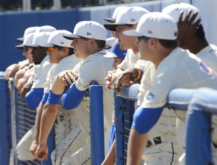 Florida players lean on the dugout railing while watching the Gators’ 14-5 win against South Carolina on April 13 at McKethan Stadium. Florida dropped the opener of its three-game series against LSU 3-2 on Thursday.