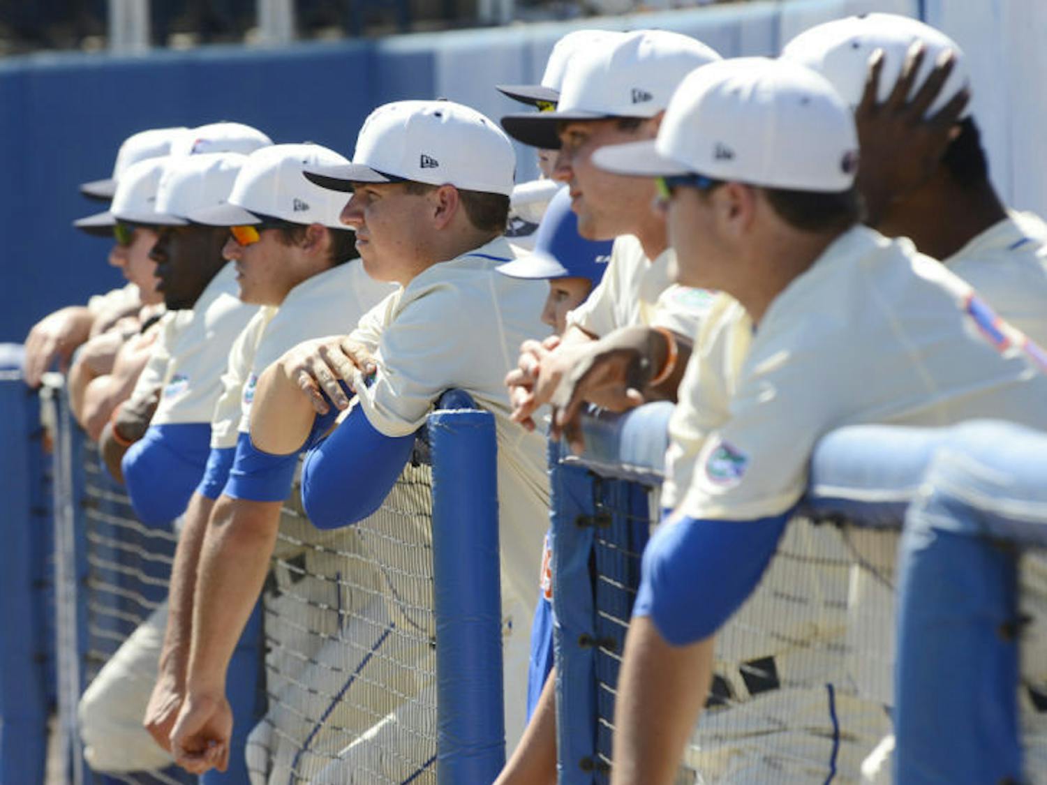 Florida players lean on the dugout railing while watching the Gators’ 14-5 win against South Carolina on April 13 at McKethan Stadium. Florida dropped the opener of its three-game series against LSU 3-2 on Thursday.