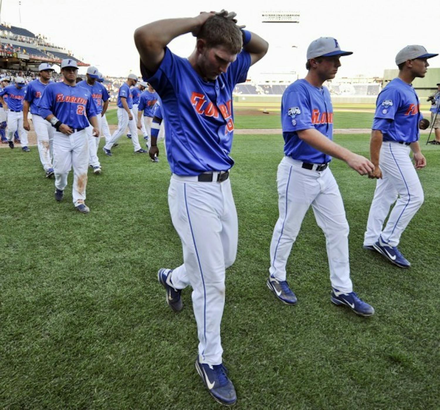 Freshman Justin Shafer walks off the field in dismay after dropping two straight games and failing to advance in the 2012 CWS. He went 2 for 5 with one RBI and stranded four runners on base in a 5-4 loss to Kent State on Monday.