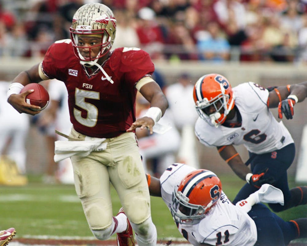 <p>Florida State quarterback Jameis Winston (5) escapes a sack attempt by Syracuse linebacker Marquis Spruill (11) during the Seminoles’ 59-3 victory against the Orange on Nov. 16 in Tallahassee.</p>