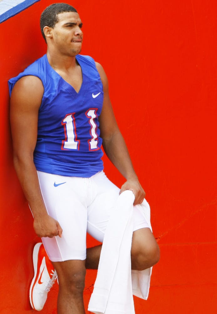 Jordan Reed (11) leans against a wall at Ben Hill Griffin Stadium after open practice on Saturday.