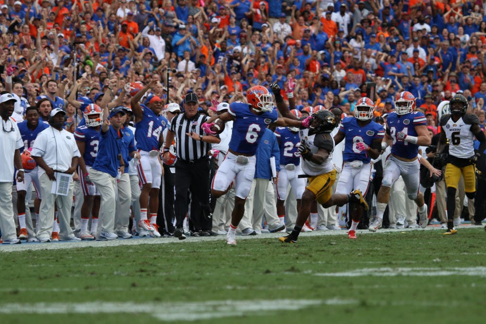Quincy Wilson (6) stiff-arms a Missouri defender after intercepting a pass during Florida's 40-14 homecoming win over Missouri on Oct. 15, 2016, at Ben Hill Griffin Stadium.