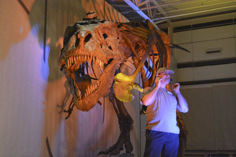<p>George Hecht, coordinator of museum operations at the Florida Museum of Natural History, speaks to an audience about Sue, the largest and most well-preserved T-rex skeleton ever found, in the museum Jan. 24.</p>