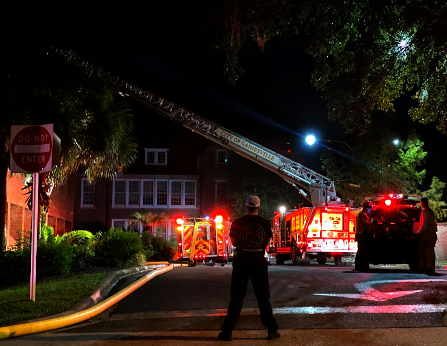 An emergency responder looks on at the scene of a fire at Norman Hall Monday night.