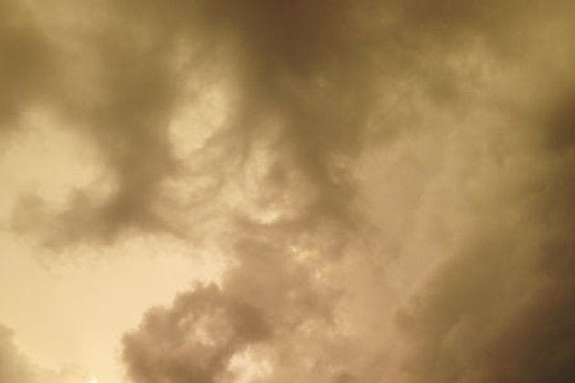 Clouds form a storm above the Museum Walk apartment complex in September.