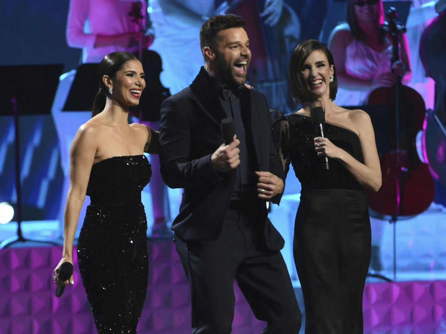 Hosts Roselyn Sanchez, from left, Ricky Martin and Paz Vega speak at the conclusion of the 20th Latin Grammy Awards on Thursday, Nov. 14, 2019, at the MGM Grand Garden Arena in Las Vegas. (AP Photo/Chris Pizzello)